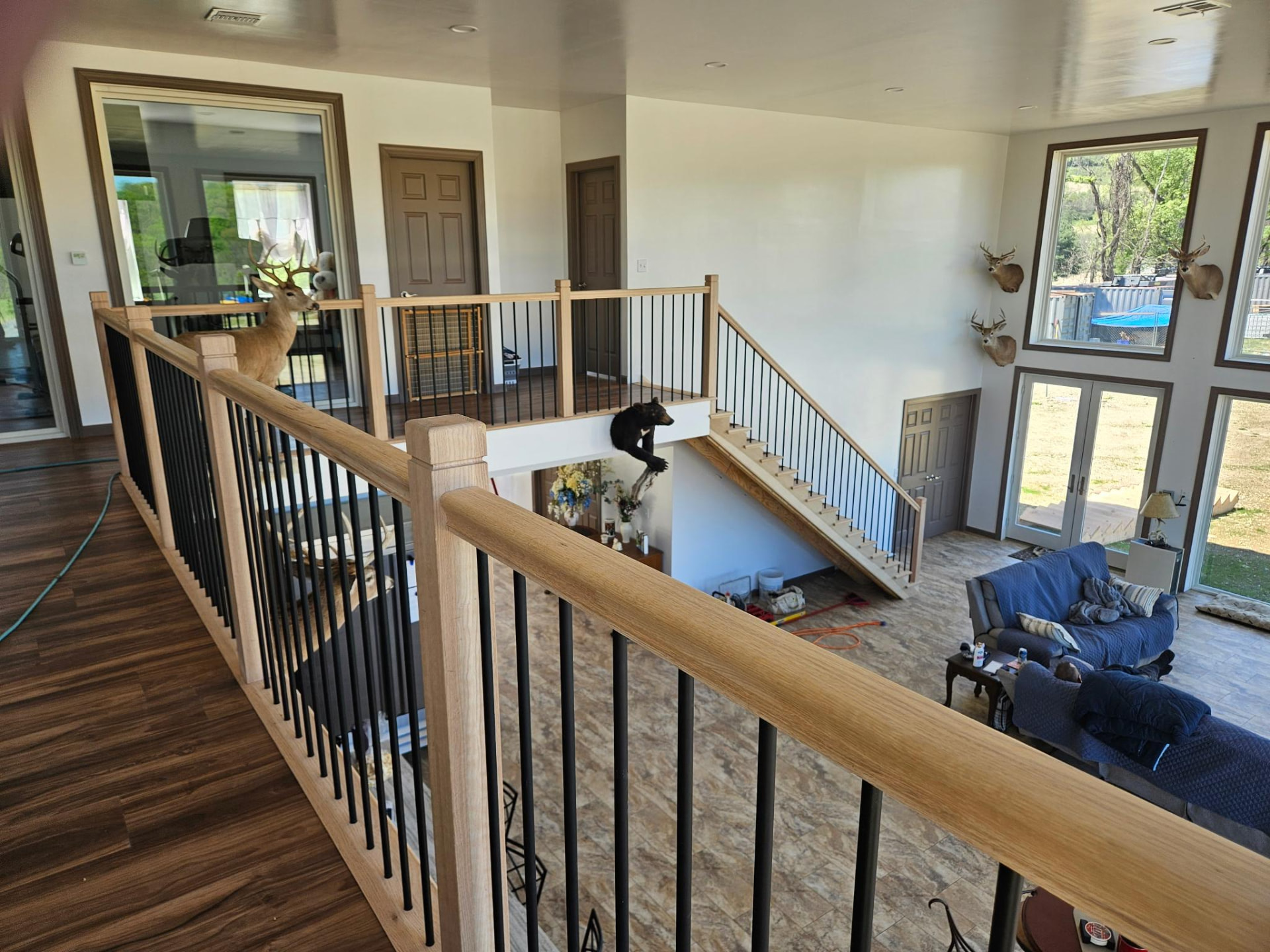 Two story great room with a custom wood stair and railing