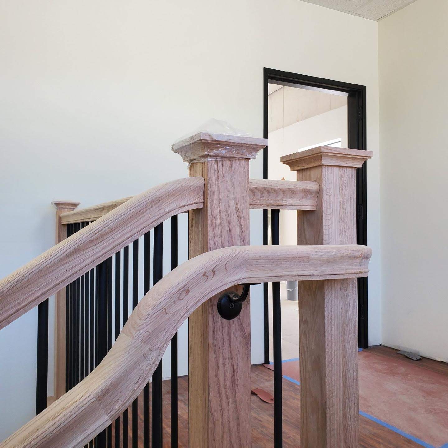 Unfinished oak railing detail with square newel posts